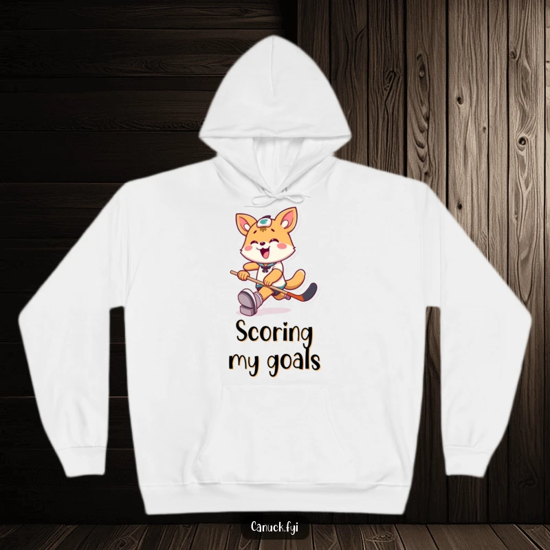Funny Hoodie: A playful animal character kicks a hockey puck with extreme joy, perfect for cozying up post-game.