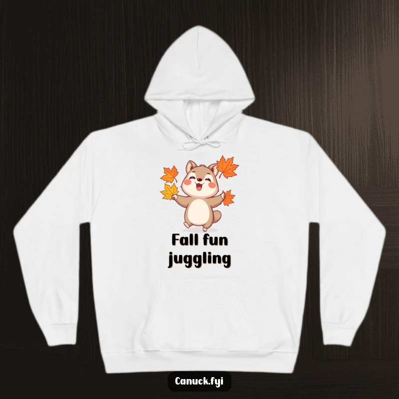 Funny hoodie showcasing a happy animal with a joyful expression, expertly juggling three stylized maple leaves, radiating autumnal charm.