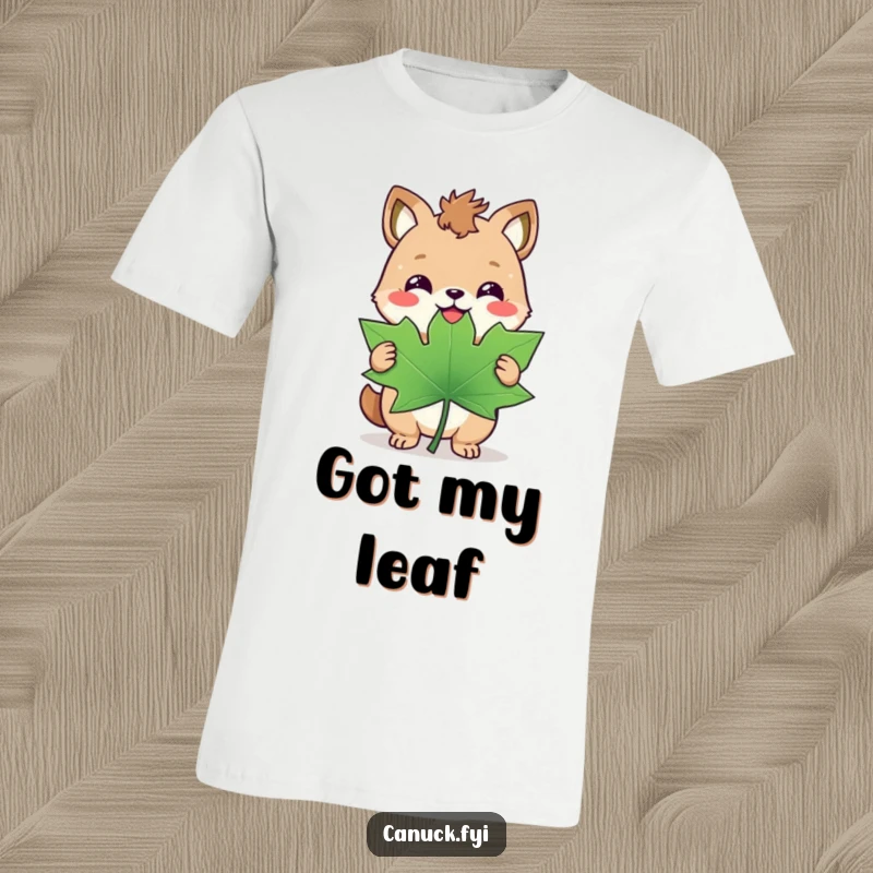 Funny T-shirt: A happy animal with a triumphant smirk clutches a giant maple leaf, celebrating Canadian victory.